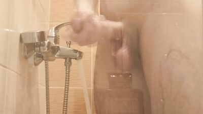 A young guy washes in the shower and plays with his dick