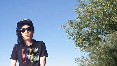 Risky public masturbation, cumshot outside, outdoors, by the water, of a twink with long black hair