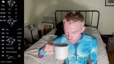 male camming model seducing viewer in his blue bedazzled superhero bodysuit (lol no homo)