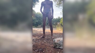 Naked boy pissing in the woods