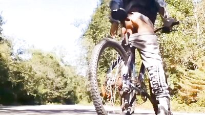 Very daring and very handsome boy plays with his bicycle in public