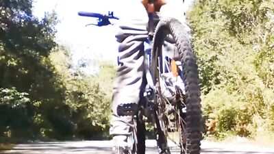 Very daring and very handsome boy plays with his bicycle in public