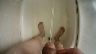 Teen boy urinating uncut penis