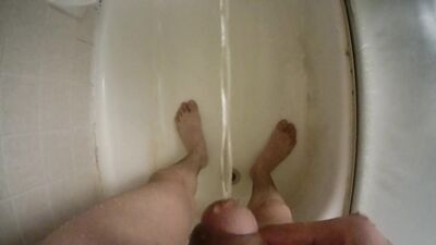 Teen boy urinating uncut penis