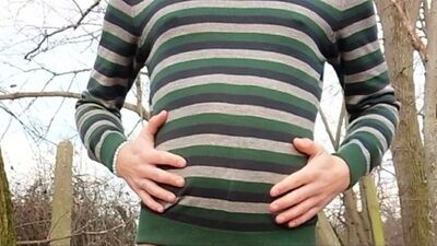 Twink belly grows under a sweater outside - air belly inflation