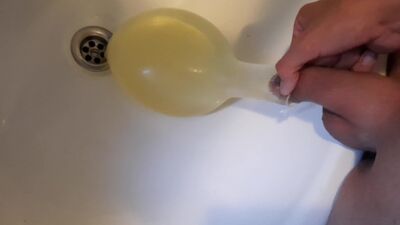 young german twink pissing in condom till its completely full and blown up like a baloon and jerking