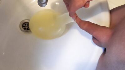 young german twink pissing in condom till its completely full and blown up like a baloon and jerking