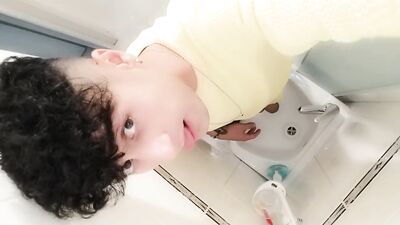 Peeing to the sink with uncut cock